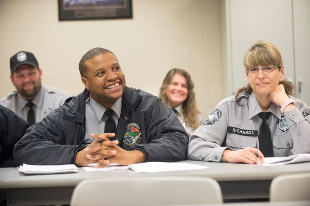 BLET students smiling at desk