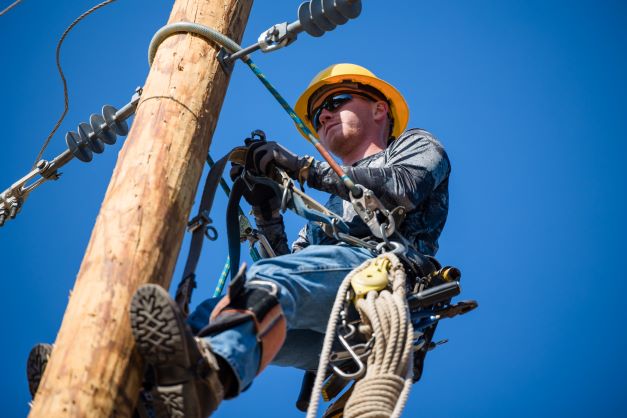 person on utility pole