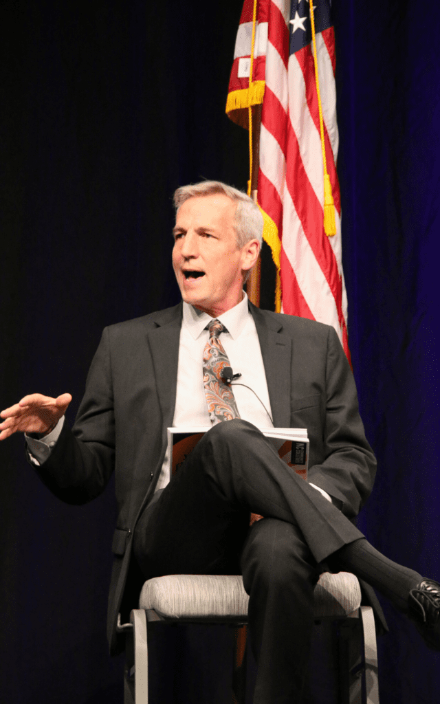 person sitting in chair speaking