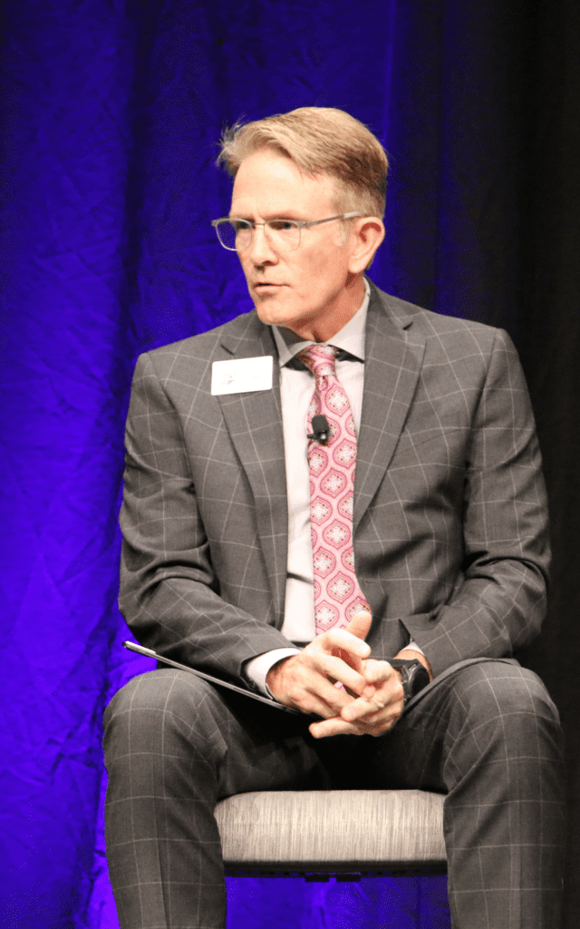person sitting in chair speaking