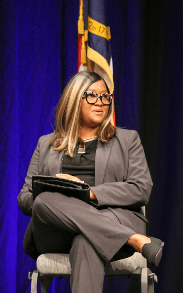person sitting in chair speaking